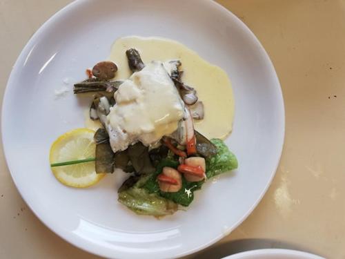 a white plate of food on a table at le relais des forêts in Blessac