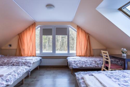 Un pat sau paturi într-o cameră la Pärnu Villa Harmony