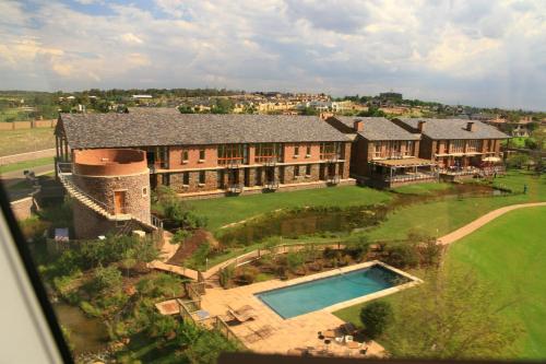 an aerial view of a large house with a swimming pool at Riboville Boutique Hotel And Restaurant in Midrand