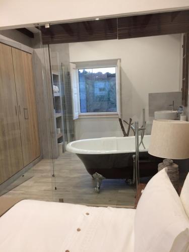 a bathroom with a bath tub and a sink at Quinta Ribeira do Labrador - Lisbon West Wine Route in Alenquer