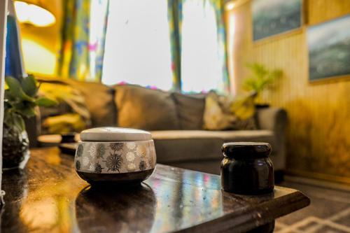 a table with a coffee cup on top of it at Eko Cozy Guest House in Saint Johnʼs