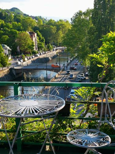 a table and chairs on a balcony overlooking a street at Apartments Emily in Sarajevo