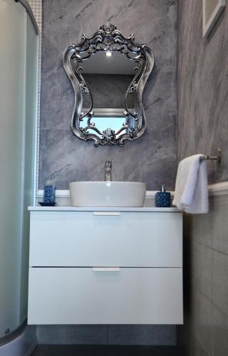 a bathroom with a white sink and a mirror at Boutique Villa Amalia in Chernomorets
