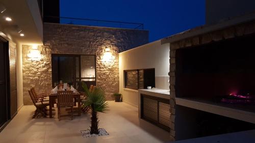 a dining room with a table and a fireplace at Villa Carisma island Vis in Vis