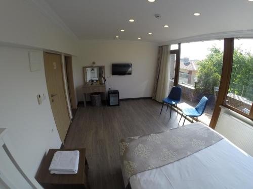 a bedroom with a bed and a table and chairs at Meydan Suites in Istanbul