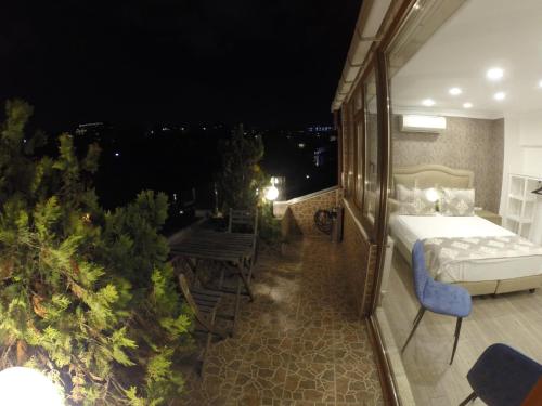 a room with a bed on a balcony at night at Meydan Suites in Istanbul
