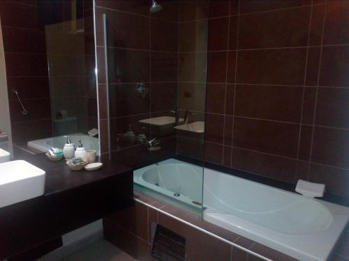 a bathroom with a tub and a sink at Urqu Hotel & Boutique in Jaén