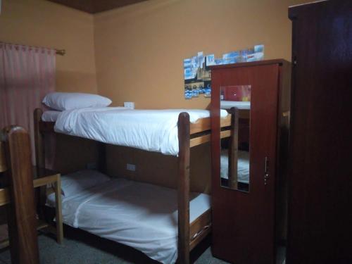 a room with two bunk beds and a cabinet at Feehi's Place in Accra