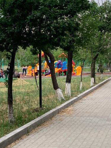 a park with a group of trees and a playground at HOTEL N1 in Yerevan