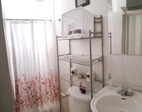 a bathroom with a toilet and a sink and a shower at Aché Tropical Studio@white-Red in San Juan