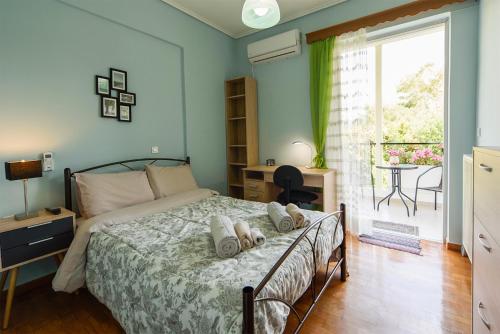 a bedroom with a bed and a window and a table at Mother's House in Athens