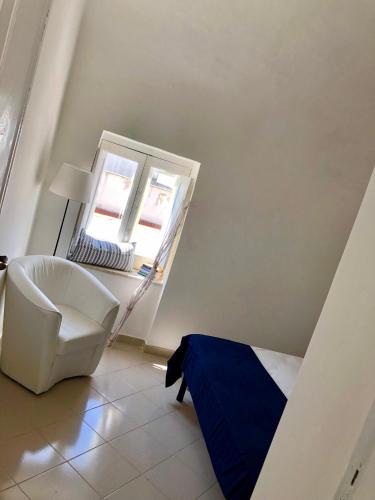 a living room with a chair and a window at Sky House Amalfi Coast in Scala