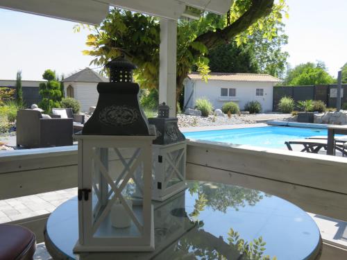 a lamp on a table next to a swimming pool at Les Rives des Habsbourg in Ensisheim