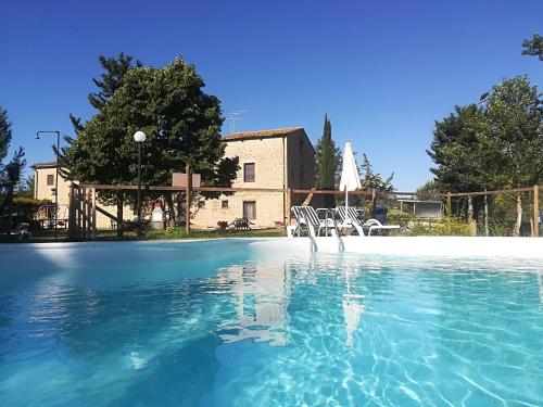 a pool of water in front of a building at Agriturismo il Palagetto in Pomarance