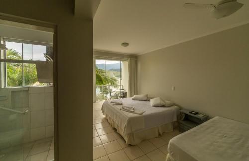 Gulta vai gultas numurā naktsmītnē Panoramica Residencial