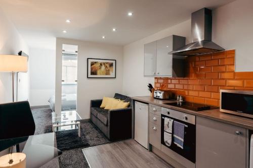 a kitchen and living room with a couch in a room at Halifax House, Studio Apartment 215 in Halifax