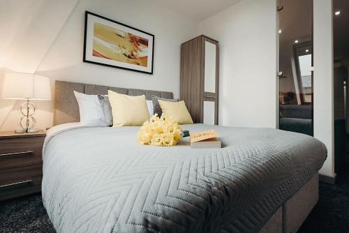 a bedroom with a large bed with a book on it at Halifax House, Studio Apartment 215 in Halifax