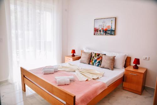 a bedroom with a bed with two towels on it at Riva Luxury in Ulcinj