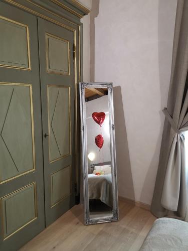 a mirror with a heart balloon in a room at Maison Croix de Ville in Aosta