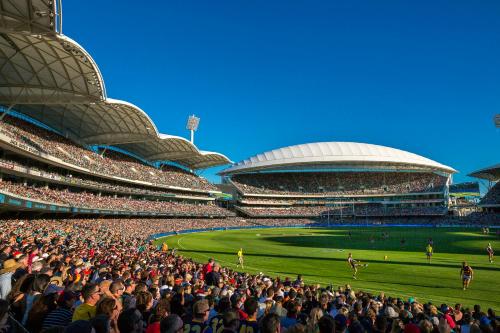 a crowd of people in a stadium watching a baseball game at Frewville Motor Inn in Adelaide