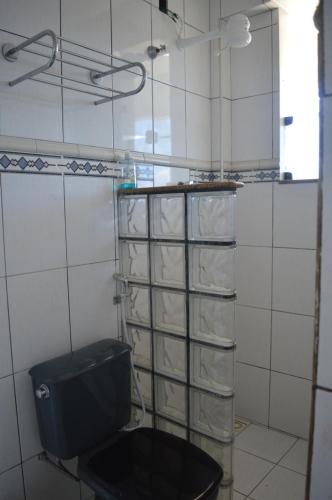 a bathroom with a toilet in a tiled room at Amazon Pier Hostel in Macapá