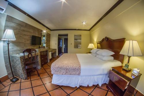 a hotel room with a bed and a bathroom at Baldi Hot Springs Hotel & Spa in Fortuna