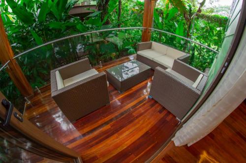a balcony with two chairs and a table at Baldi Hot Springs Hotel & Spa in Fortuna