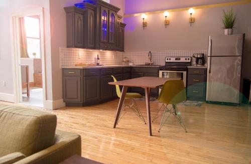 a kitchen with a table and a refrigerator at School 31 Lofts in Rochester