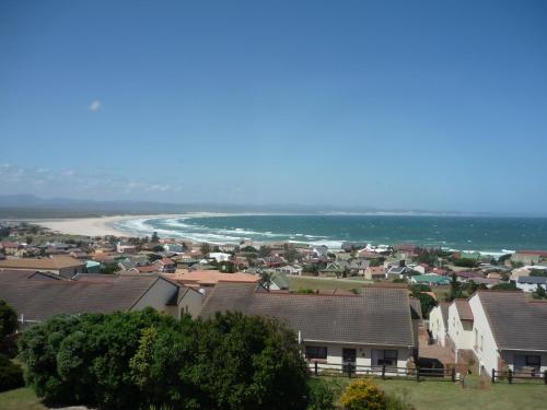 a town with houses and a beach and the ocean at A1 Kynaston Guest House bed and breakfast or self catering in Jeffreys Bay