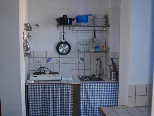 a small kitchen with a sink and a stove at Ikion Studios in Steni Vala Alonissos