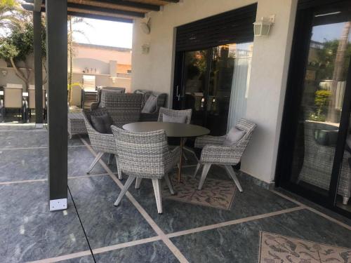 a table and chairs sitting on a patio at sul mare סוויטות in Ashqelon