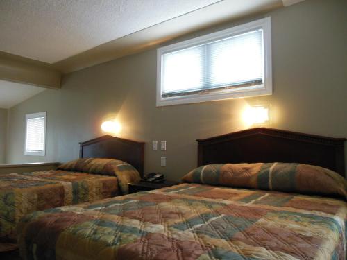 Un ou plusieurs lits dans un hébergement de l'établissement Motor Court Motel