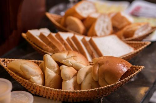 a bunch of breads and other food in baskets at Vision Premier Hotel & Spa in Hanoi