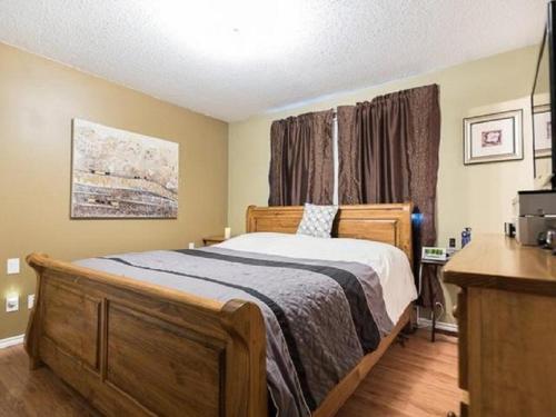 a bedroom with a bed and a desk in it at Wild North Bed & Rest in Whitehorse