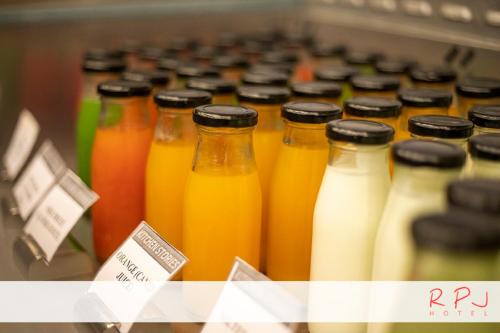 a row of bottles of juice on a shelf at RPJ Hotel Rajkot in Rajkot