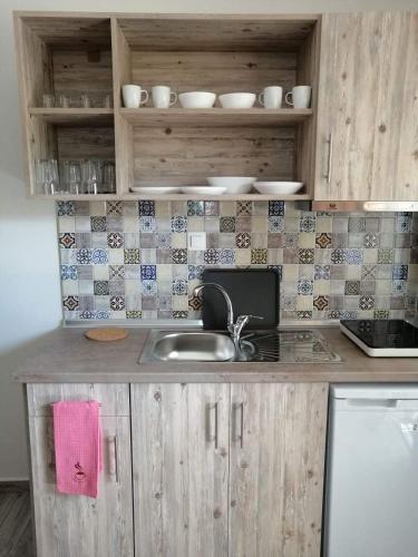 a kitchen with a sink and a counter top at Ethra luxury studios in Asprovalta