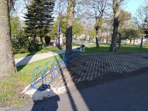 a blue bench in a park next to trees at Penzion U Soudu in Hora Svatého Šebestiána