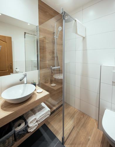 a bathroom with a sink and a shower at Pension Auszeit Velden in Velden am Wörthersee