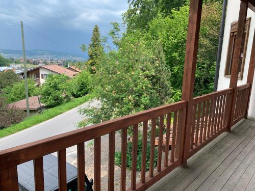 a wooden balcony with a view of a road at Bed & Breakfast Region Murtensee in Münchenwiler