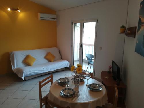 a living room with a table and a couch at Apartments 2D in Grebaštica