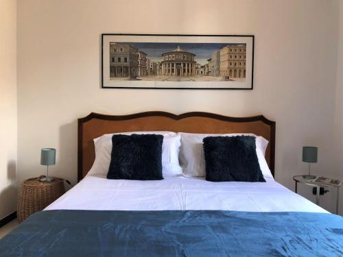 a bedroom with a large bed with black pillows at ARDUINO AL TRE in Alghero