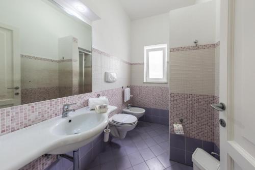 a bathroom with a sink and a toilet at Ischia Dream Sunset in Ischia