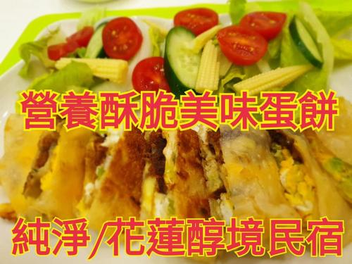 a plate of food with a sandwich and vegetables at 醇境民宿市區車庫停車場 in Hualien City