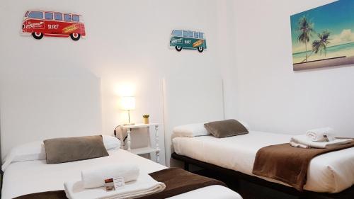 a room with two beds and a van on the wall at URBIETA CENTRO in Donostia-San Sebastián