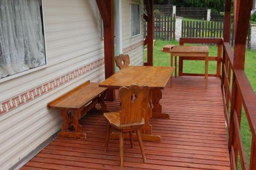a porch with a wooden table and benches on it at ubytování na kopečku in Velké Svatoňovice