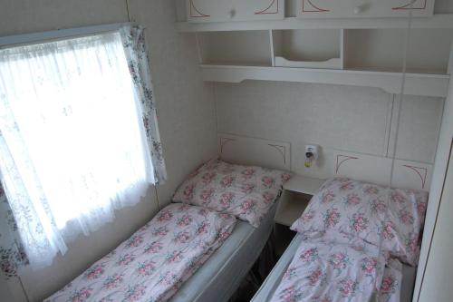 two beds in a small room with a window at ubytování na kopečku in Velké Svatoňovice