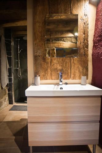 a bathroom with a white sink and a mirror at Can Poca Roba in Sant Pere de Torelló