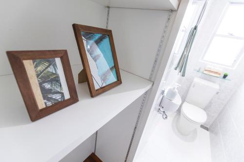two mirrors on a shelf in a bathroom with a toilet at パームヴィラ-貸切プライベート-最大10名様のバケーションステイ-駐車場付き in Yaese