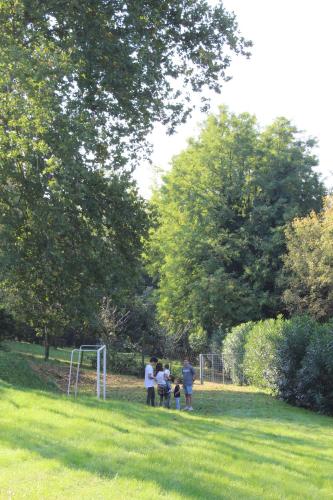 a group of people standing in a field with a soccer ball at Corte Attilea in Valeggio sul Mincio