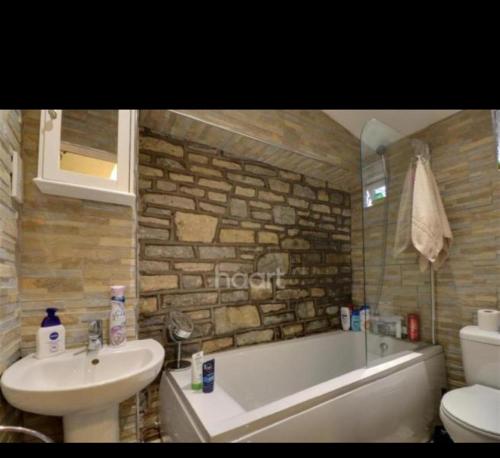 a bathroom with a sink and a tub and a toilet at Beautiful Apartments in Bristol